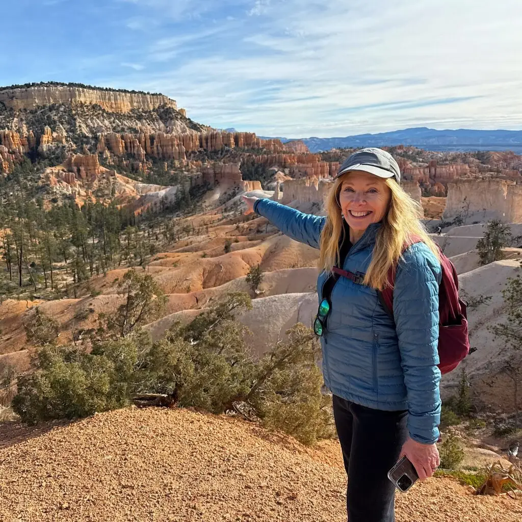 Karen Smith pointing to the top of the Fairyland Loop Trail in Bryce Canyon National Park, Utah